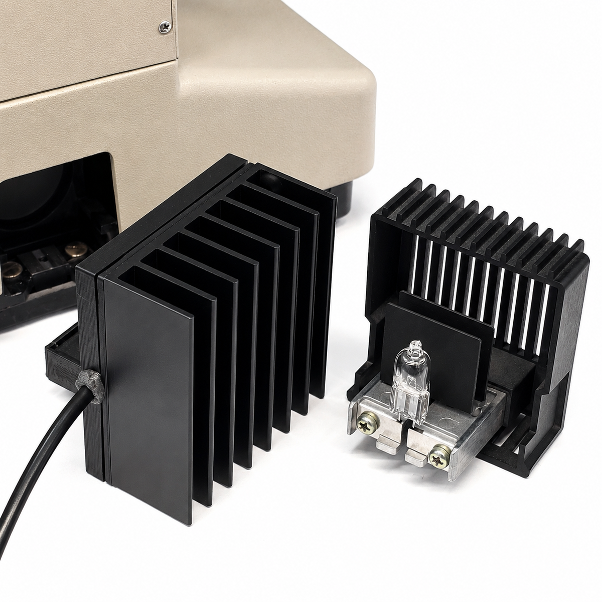 Black metal heat sinks with a light bulb on a white background